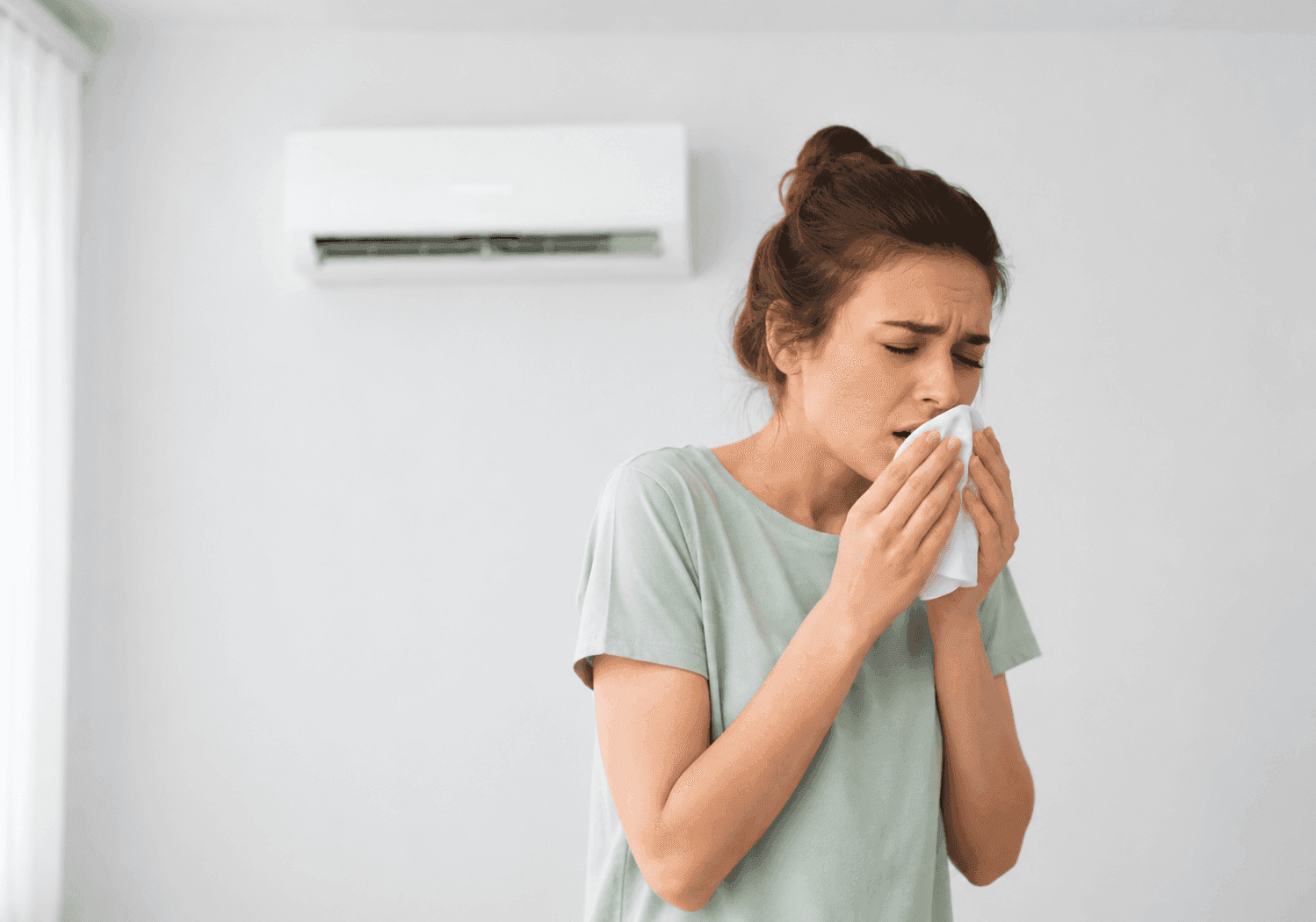 Homeowner experiencing irritation while using an air conditioner during humid weather